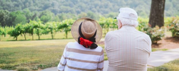 An elderly couple sitting down